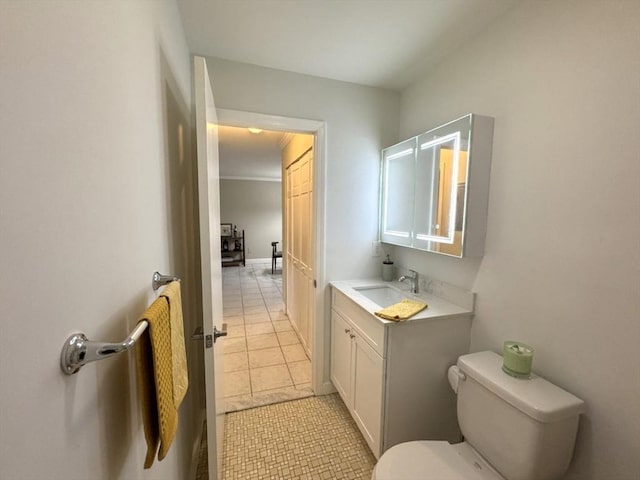 bathroom featuring toilet, tile patterned floors, and vanity