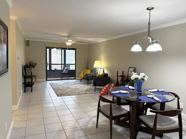 dining area featuring baseboards, visible vents, crown molding, and light tile patterned flooring