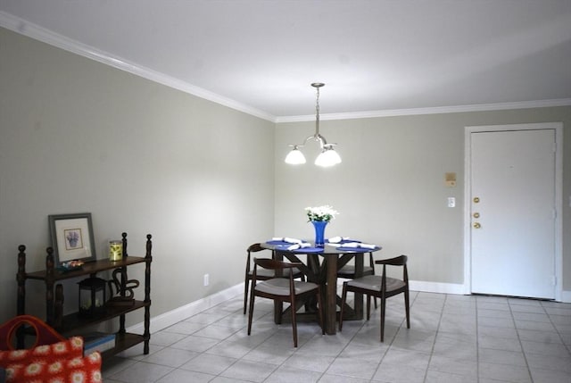 dining space with a notable chandelier, baseboards, and crown molding