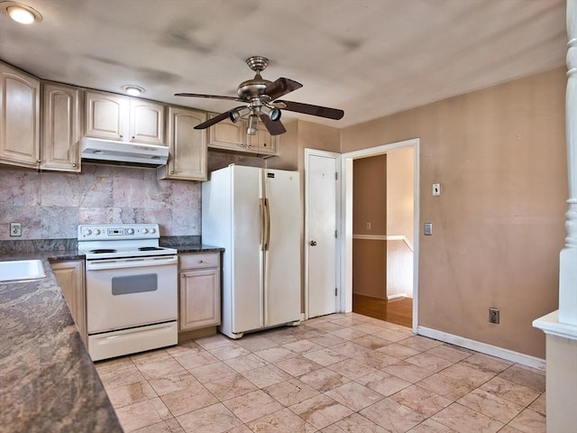 kitchen featuring dark countertops, under cabinet range hood, decorative backsplash, white appliances, and a sink