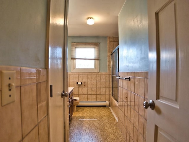 full bath with tile walls, toilet, shower / bath combination with glass door, and a baseboard radiator