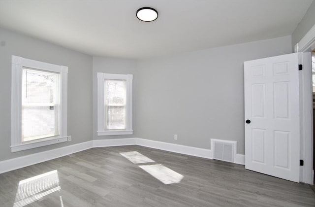 spare room with hardwood / wood-style flooring