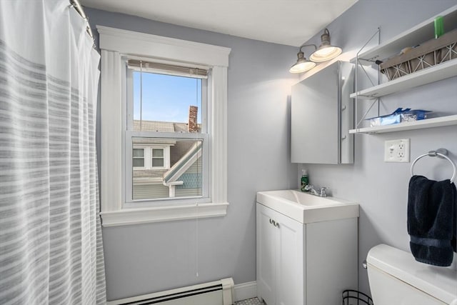 bathroom with toilet, vanity, and a baseboard radiator