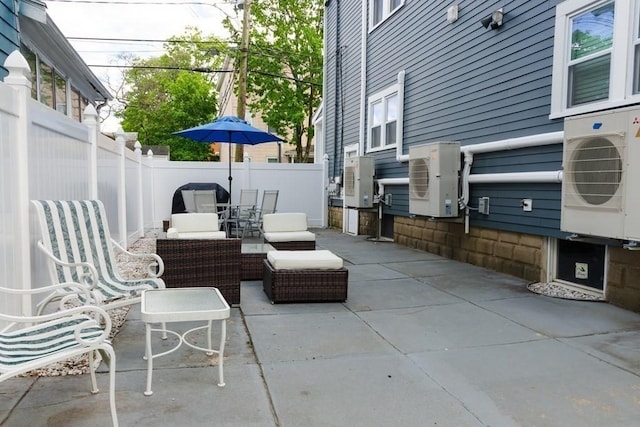 view of patio / terrace featuring ac unit and fence