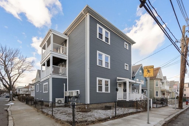 exterior space featuring a fenced front yard and a residential view