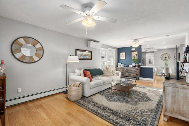 living area featuring light wood-type flooring, a baseboard radiator, ceiling fan, and a wall unit AC