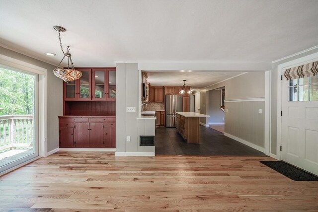 313 Bennett Rd, Hampden, MA 01036 - kitchen featuring stainless steel appliances, a chandelier, wood finished floors, light countertops, and a sink