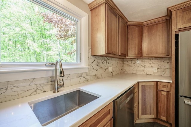 313 Bennett Rd, Hampden, MA 01036 - kitchen featuring stainless steel appliances, a sink, tasteful backsplash, and brown cabinets