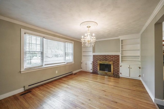 313 Bennett Rd, Hampden, MA 01036 - unfurnished living room featuring a baseboard radiator, a chandelier, baseboards, light wood-style flooring, and built in shelves