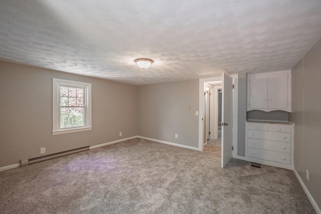 313 Bennett Rd, Hampden, MA 01036 - unfurnished bedroom with a baseboard radiator, a textured ceiling, light carpet, and baseboards