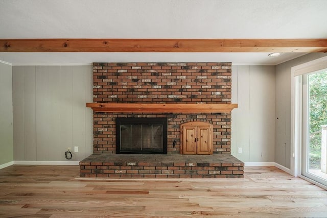 313 Bennett Rd, Hampden, MA 01036 - unfurnished living room featuring wood finished floors, a brick fireplace, baseboards, beamed ceiling, and wooden walls