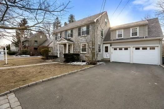 colonial house featuring driveway and an attached garage