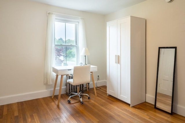 office area with wood finished floors and baseboards