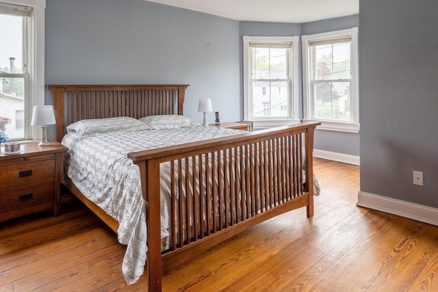 bedroom featuring baseboards and wood finished floors