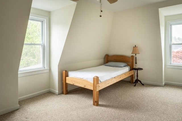 bedroom with light carpet, baseboards, and a ceiling fan