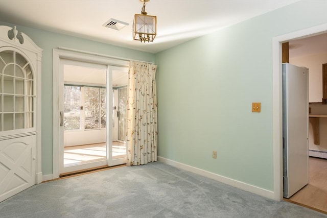 interior space with carpet floors, a baseboard radiator, visible vents, and baseboards