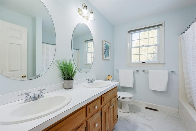 bathroom with vanity, plenty of natural light, and toilet