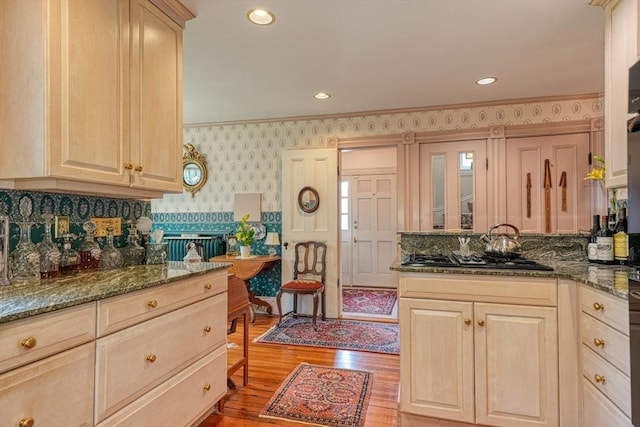 70 Main St, Northborough, MA 01532 - kitchen featuring stainless steel gas stovetop, wallpapered walls, light brown cabinetry, light wood-type flooring, and a peninsula