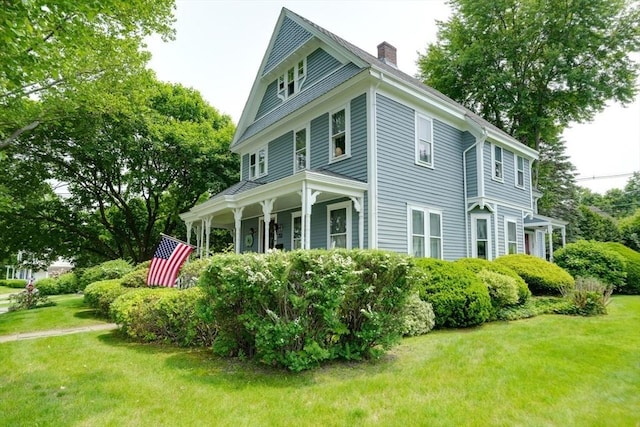 70 Main St, Northborough, MA 01532 - view of side of property featuring a chimney, a yard, and a porch
