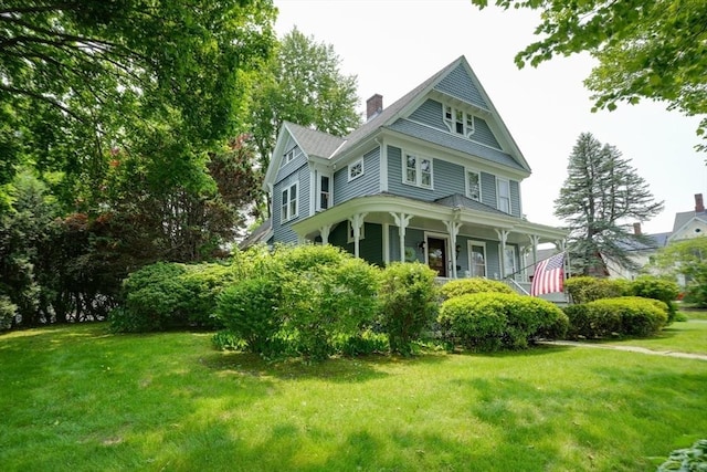 70 Main St, Northborough, MA 01532 - victorian home featuring a porch, a front lawn, and a chimney