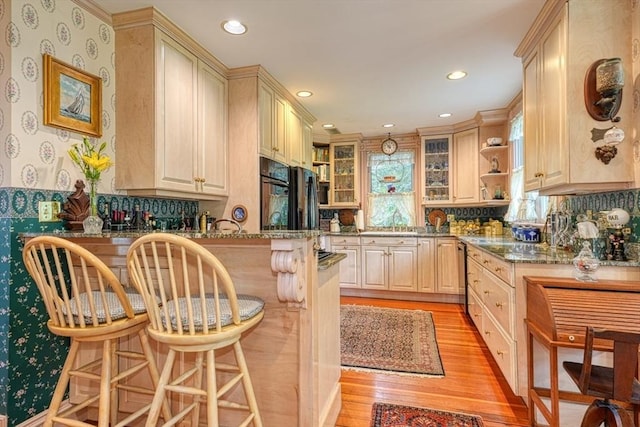 70 Main St, Northborough, MA 01532 - kitchen with a kitchen bar, light wood finished floors, open shelves, a peninsula, and glass insert cabinets