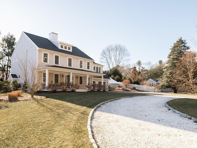 view of front of home featuring a front yard and covered porch