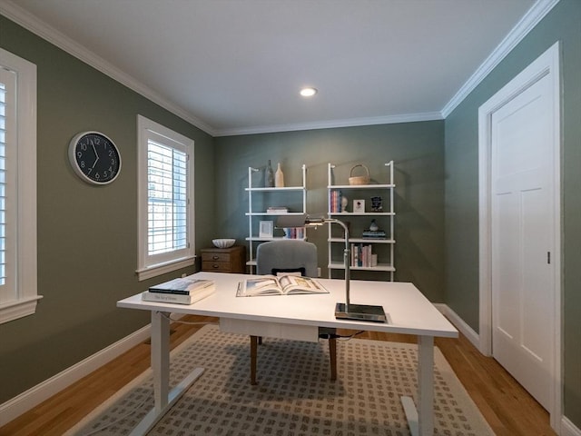 office area with light hardwood / wood-style floors and crown molding