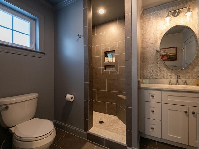 bathroom featuring toilet, vanity, crown molding, and tile patterned flooring