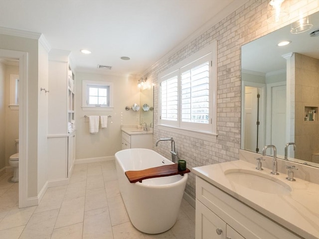 full bathroom featuring toilet, vanity, ornamental molding, and shower with separate bathtub