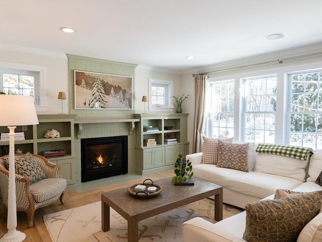 living room with a brick fireplace and crown molding