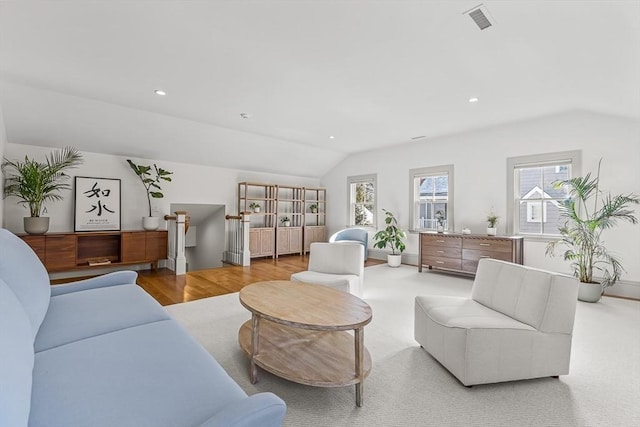 living room with vaulted ceiling and light wood-type flooring