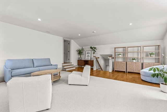 living room featuring lofted ceiling and hardwood / wood-style flooring