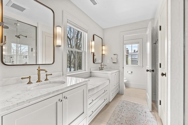 bathroom featuring vanity, toilet, and tile patterned flooring