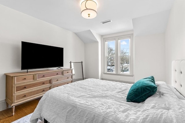 bedroom with dark hardwood / wood-style flooring