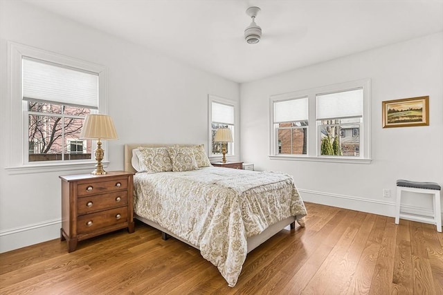 bedroom featuring hardwood / wood-style flooring and multiple windows