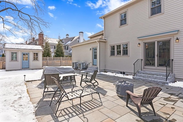 snow covered patio with an outbuilding