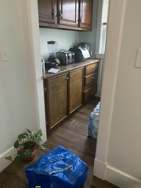 295 Grove St, Brockton, MA 02302 - bar featuring dark wood finished floors and baseboards