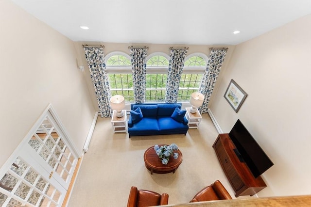 carpeted living area with recessed lighting, a wealth of natural light, and baseboards
