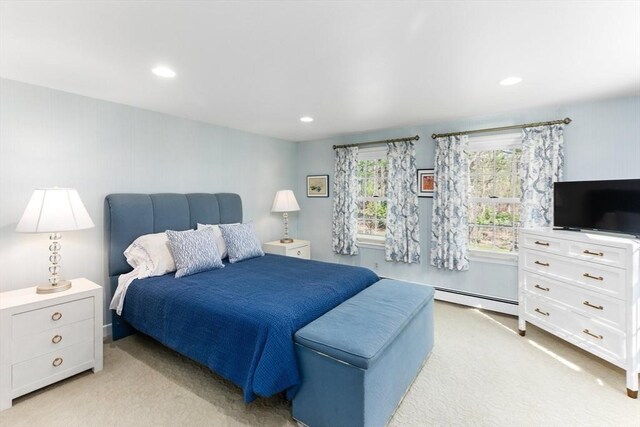 bedroom featuring light carpet, baseboard heating, and recessed lighting