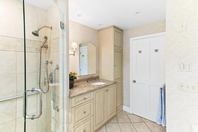 full bathroom with a shower stall, tile patterned floors, and vanity