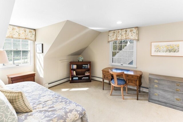 carpeted bedroom with a baseboard heating unit and multiple windows