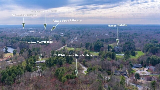 birds eye view of property with a forest view