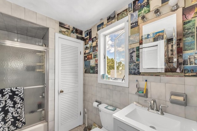 419 Poplar St, Boston, MA 02131 - full bathroom with tile walls, combined bath / shower with glass door, vanity, and a closet