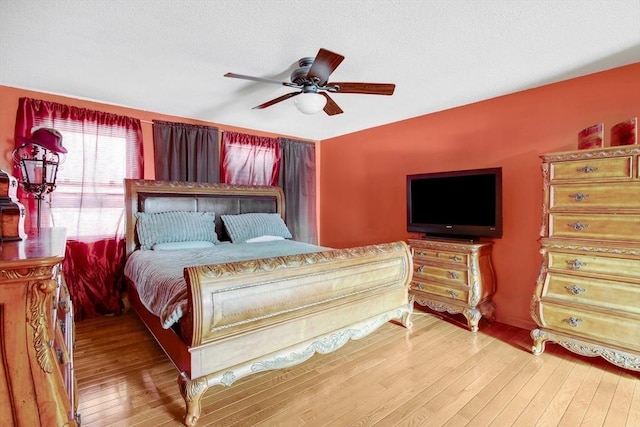 bedroom with light wood-type flooring and a ceiling fan