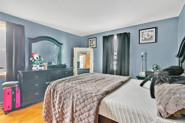 bedroom featuring a textured ceiling and light wood-style flooring