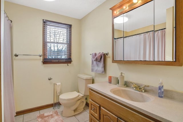 full bathroom featuring toilet, baseboards, vanity, and tile patterned floors