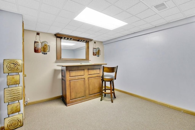 bar featuring baseboards, light colored carpet, visible vents, and a bar