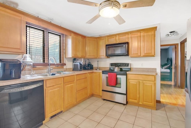 kitchen featuring black appliances, visible vents, light countertops, and a sink