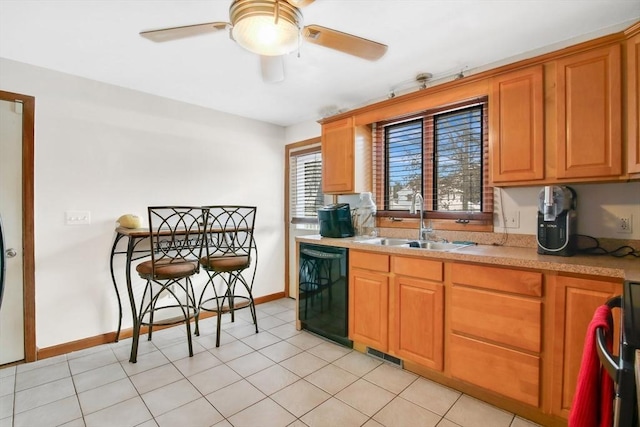 kitchen featuring black dishwasher, brown cabinets, light countertops, visible vents, and a sink