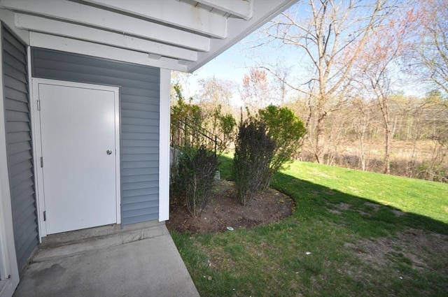 entrance to property featuring a lawn